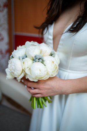 Beautiful wedding bouquet of flowers in the hands of the newlywedsの写真素材