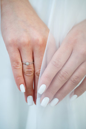 gold wedding rings in the hands of the newlywedsの写真素材