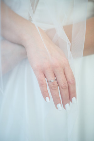 gold wedding rings in the hands of the newlywedsの写真素材