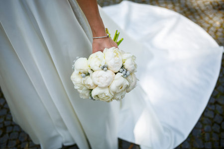 Beautiful wedding bouquet of flowers in the hands of the newlywedsの写真素材