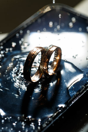 Wedding rings with water droplets,The engagement ring set.,Beautiful silver background with wedding...