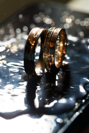 Wedding rings with water droplets,The engagement ring set.,Beautiful silver background with wedding rings and starsの写真素材