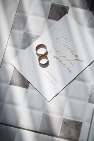 gold wedding rings on the wedding day for the newlyweds. Jewelry from expensive metalの写真素材