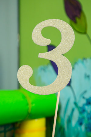 Numbers carved from wood on a standの写真素材