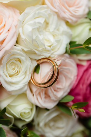 gold wedding rings on the wedding day for the newlyweds. Jewelry from expensive metalの写真素材