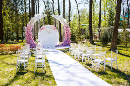 Festive arch for the ceremony of painting the newlyweds on the wedding day, wedding decor with fresh flowersの写真素材