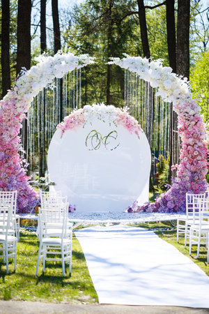 Festive arch for the ceremony of painting the newlyweds on the wedding day, wedding decor with fresh flowersの写真素材