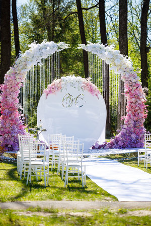 Festive arch for the ceremony of painting the newlyweds on the wedding day, wedding decor with fresh flowersの写真素材