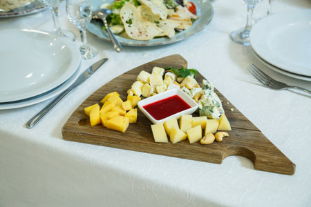 Cheese plate, cheese, different types of cheese on a wooden board, cheese sauceの写真素材
