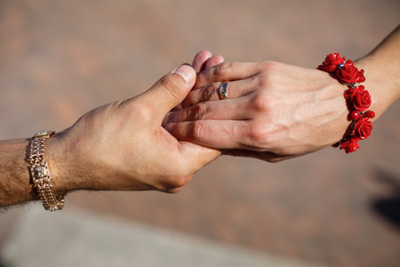 Bride and groom hold hands on wedding dayの写真素材