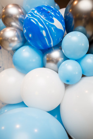 Blue balloons, holiday helium balloons, many inflated balloonsの写真素材