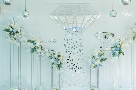 Beautiful wedding arch of flowers for the newlyweds. Decoration on a holidayの写真素材
