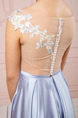 The back of a girl in a dress with buttonsの写真素材