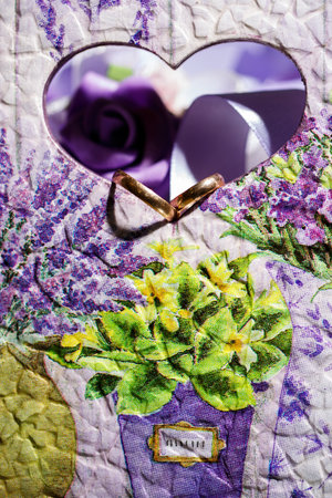 Purple heart and two wedding ringsの写真素材