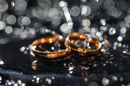 Wedding rings with water droplets,The engagement ring set.,Beautiful silver background with wedding...