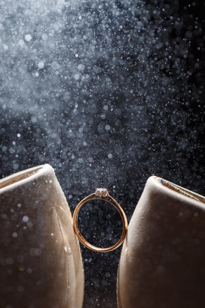 Gold wedding ring with women's shoes on the wedding day