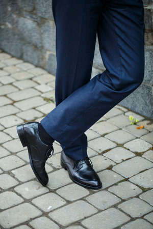 Man puts on a wedding suit and accessories on the wedding day.