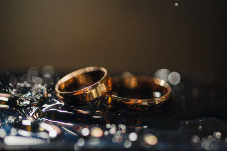 Wedding rings with water droplets,The engagement ring set.,Beautiful silver background with wedding...