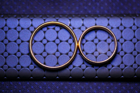 Gold wedding rings for newlyweds on wedding dayの写真素材