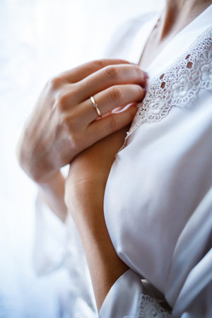 gold wedding rings in the hands of the newlywedsの写真素材