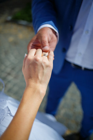 gold wedding rings in the hands of the newlywedsの写真素材