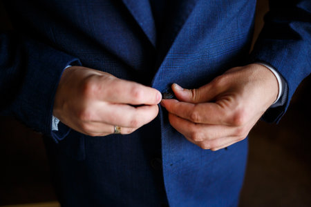 man puts on a suit on the wedding dayの写真素材