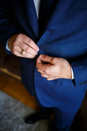 man puts on a suit on the wedding dayの写真素材
