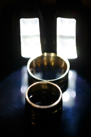 Gold wedding ring on black glassの写真素材