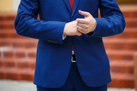 man puts on a suit on the wedding dayの写真素材