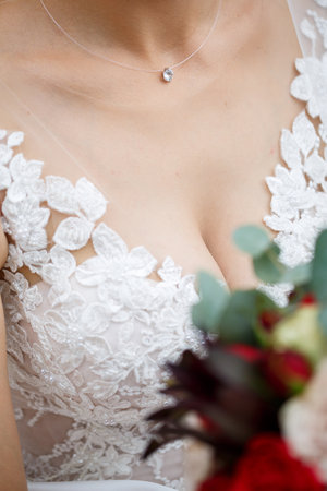 Beautiful wedding bouquet of flowers in the hands of the newlywedsの写真素材
