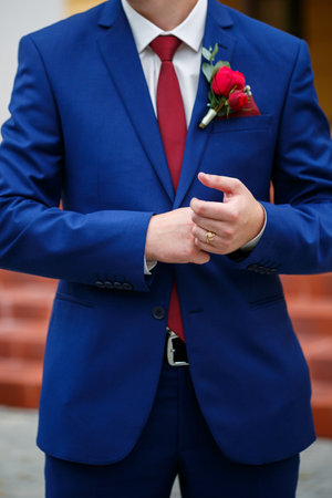 man puts on a suit on the wedding dayの写真素材