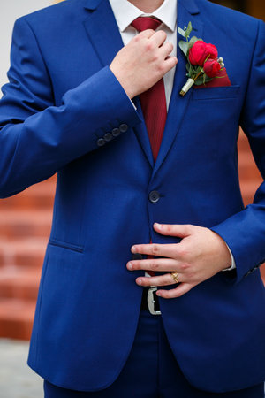 man puts on a suit on the wedding dayの写真素材