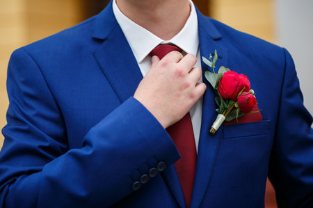 man puts on a suit on the wedding dayの写真素材