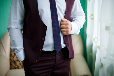 man puts on a suit on the wedding dayの写真素材