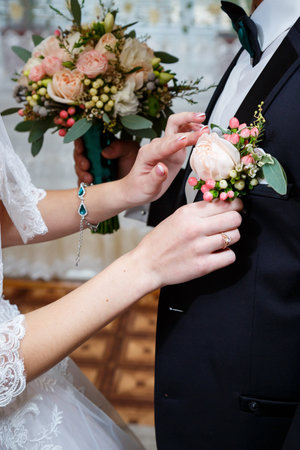 Beautiful wedding bouquet of flowers in the hands of the newlywedsの写真素材