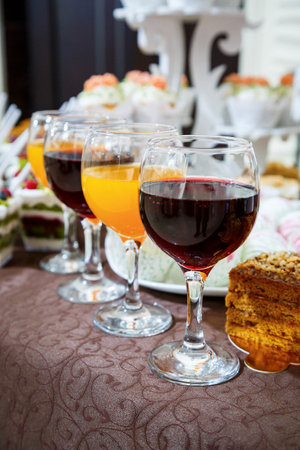 glass goblets with red and orange juiceの写真素材