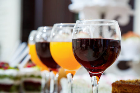 glass goblets with red and orange juiceの写真素材