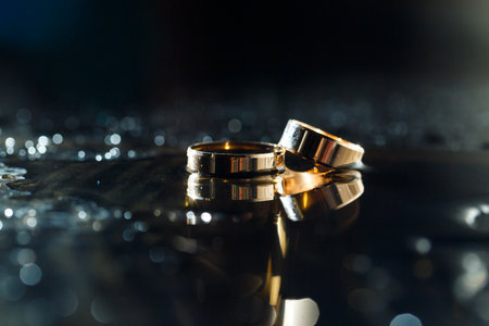 Gold wedding rings with water splashesの写真素材