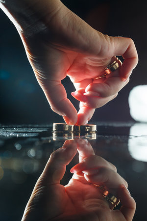 Gold wedding rings with water splashesの写真素材