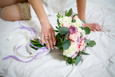 Wedding bouquet in the hands of the newlywedの写真素材