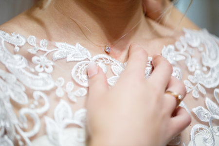 bride puts on wedding jewelry on the wedding dayの写真素材