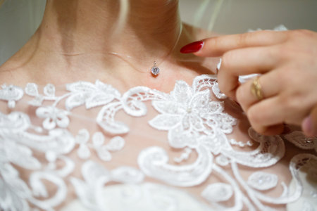 bride puts on wedding jewelry on the wedding dayの写真素材