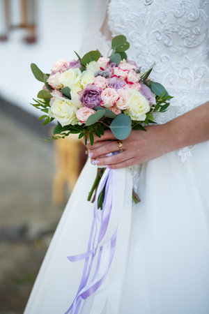 Wedding bouquet in the hands of the newlywedの写真素材