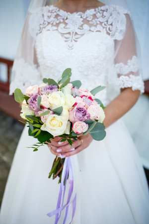 Wedding bouquet in the hands of the newlywedの写真素材