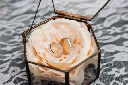 gold wedding rings on the wedding day for the newlyweds. Jewelry from expensive metalの写真素材
