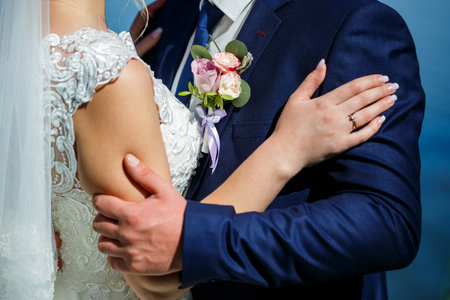 Bride and groom hugging on a wedding dayの写真素材