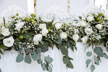 Beautiful wedding arch of flowers for the newlyweds. Decoration on a holidayの写真素材