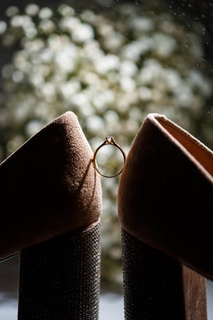 Bride's engagement ring on wedding day with beautiful holiday shoesの写真素材