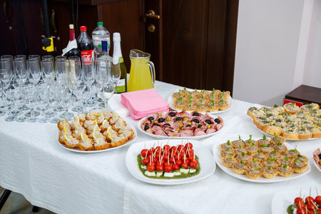 Buffet table for guests at a banquet with various snacks and sandwichesの写真素材