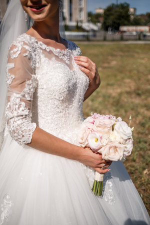 A bouquet of fresh flowers in the hands of the brideの写真素材